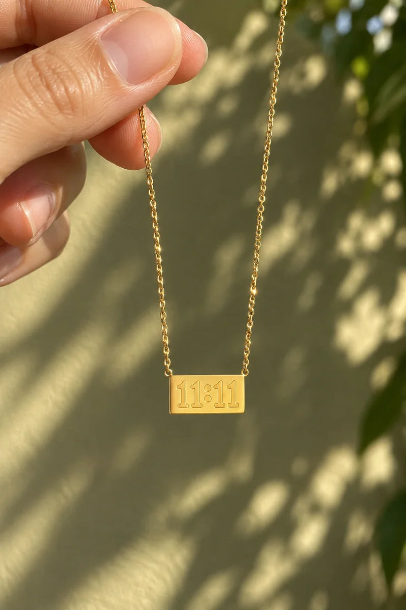 Lucky Elevens Necklace held in warm afternoon light